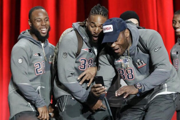 New England Patriots' Martellus Bennett and Brandon Bolden take a selfie during opening night for the NFL Super Bowl 51 football game at Minute Maid Park Monday, Jan. 30, 2017, in Houston. (AP Photo/David J. Phillip)