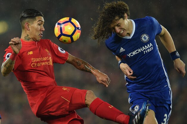 Liverpool's Brazilian midfielder Roberto Firmino (L) vies with Chelsea's Brazilian defender David Luiz during the English Premier League football match between Liverpool and Chelsea at Anfield in Liverpool, north west England on January 31, 2017. / AFP / PAUL ELLIS / RESTRICTED TO EDITORIAL USE. No use with unauthorized audio, video, data, fixture lists, club/league logos or 'live' services. Online in-match use limited to 75 images, no video emulation. No use in betting, games or single club/league/player publications.  /         (Photo credit should read PAUL ELLIS/AFP/Getty Images)