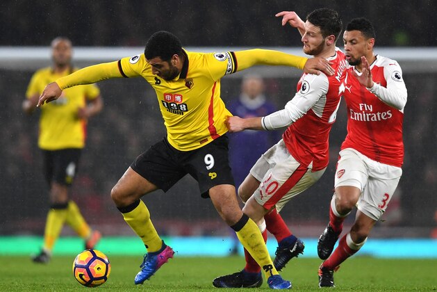 LONDON, ENGLAND - JANUARY 31:  Troy Deeney of Watford and Shkodran Mustafi of Arsenal compete for the ball during the Premier League match between Arsenal and Watford at Emirates Stadium on January 31, 2017 in London, England.  (Photo by Shaun Botterill/Getty Images)