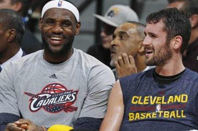 Cleveland Cavaliers forward LeBron James, left, and Kevin Love confer while on the bench  as the Cavaliers face the Denver Nuggets in the third quarter of the Cavaliers' 110-101 victory in an NBA basketball game in Denver on Friday, Nov. 7, 2014. (AP Photo/David Zalubowski)