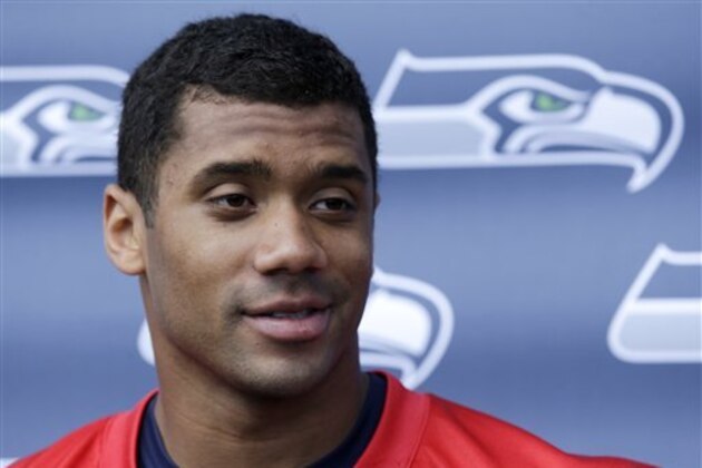 Seattle Seahawks quarterback Russell Wilson is interviewed after an NFL football minicamp Tuesday, June 11, 2013, in Renton, Wash. (AP Photo/Elaine Thompson)