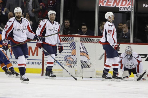 Washington Capitals' Daniel Winnik (26), Brooks Orpik (44), Jay Beagle (83) and during the third period of an NHL hockey game after New York Islanders' Ryan Strome scored a goal, Tuesday, Jan. 31, 2017, in New York. The Islanders won 3-2. (AP Photo/Frank Franklin II)