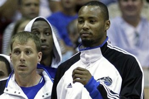 In this Oct. 7, 2009 photo, Orlando Magic forward Rashard Lewis, right, and teammate guard Jason Williams watch play during the first half of a preseason NBA basketball game against the Miami Heat in Orlando, Fla. Just peeking inside the medicine cabinet these days gives Lewis chills. He won't even take headache medicine. He won't take anything, really, without approval. Being suspended by the NBA for the first 10 games of this season after testing positive for an elevated level of testosterone has made the Orlando Magic All-Star forward nervous about everything he ingests.  (AP Photo/John Raoux)