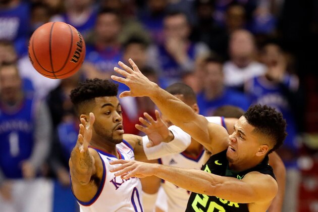 LAWRENCE, KS - FEBRUARY 01:  Manu Lecomte #20 of the Baylor Bearspasses as Frank Mason III #0 of the Kansas Jayhawks defends during the game at Allen Fieldhouse on February 1, 2017 in Lawrence, Kansas.  (Photo by Jamie Squire/Getty Images)