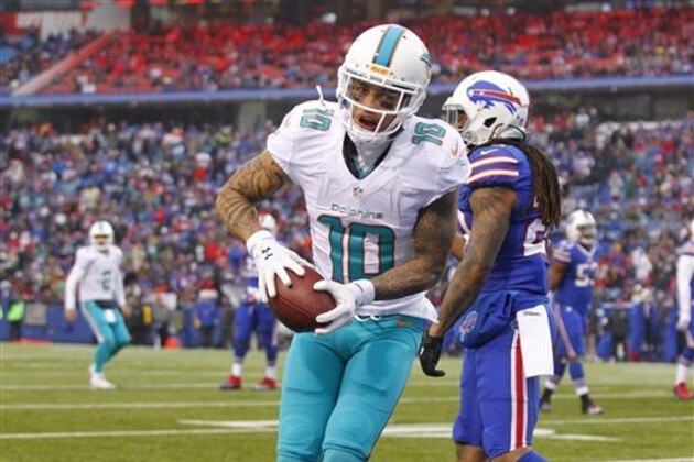 Miami Dolphins wide receiver Kenny Stills (10) celebrates his touchdown in front of Buffalo Bills' Ronald Darby (28) as quarterback Matt Moore (8) watches him during the second half of an NFL football game Saturday, Dec. 24, 2016, in Orchard Park, N.Y. (AP Photo/Bill Wippert)