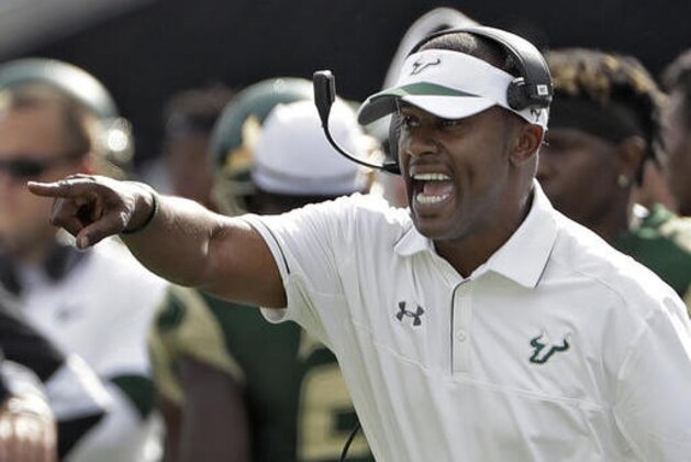FILE - In this Nov. 26, 2016, file photo, South Florida head coach Willie Taggart shouts instructions to his team during the second half of an NCAA college football game against Central Florida, in Tampa, Fla. South Florida football coach Willie Taggart has informed the school that he is leaving to become the coach at Oregon, a person with direct knowledge of the situation tells The Associated Press. The person spoke on condition of anonymity because neither school was prepared to make an official announcement. (AP Photo/Chris O'Meara, File)
