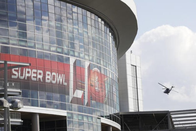 A helicopter flies over NRG Stadium for the NFL Super Bowl 51 football game Wednesday, Feb. 1, 2017, in Houston. (AP Photo/Morry Gash)
