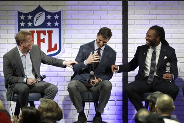 NFL Commissioner Roger Goodell, left, and Walter Payton NFL Man of the Year finalist Larry Fitzgerald, right, joke with fellow finalist Eli Manning, center, during a fan forum for the NFL Super Bowl 51 football game Friday, Feb. 3, 2017, in Houston. (AP Photo/David J. Phillip)
