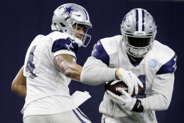 FILE - In this Wednesday, Jan. 11, 2017, file photo, Dallas Cowboys running back Ezekiel Elliott (21) takes the handoff from quarterback Dak Prescott (4) during NFL football practice at the team's headquarters in Frisco, Texas. Aaron Rodgers has been unbeatable on a seven-game run that carried the Green Bay Packers to a divisional-round game against Dallas. So was Cowboys rookie Dak Prescott for 11 straight in the regular season, giving him the No. 1 seed for his playoff debut Sunday. (AP Photo/LM Otero, File)