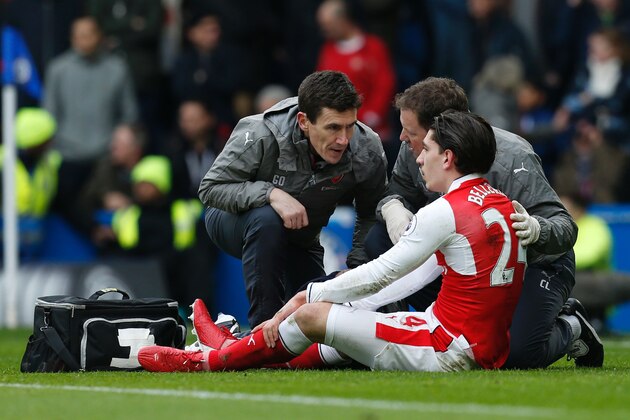 Arsenal's Spanish defender Hector Bellerin receives attention on the pitch after clashing in the air with Chelsea's Spanish defender Marcos Alonso during the English Premier League football match between Chelsea and Arsenal at Stamford Bridge in London on February 4, 2017. / AFP / Ian KINGTON / RESTRICTED TO EDITORIAL USE. No use with unauthorized audio, video, data, fixture lists, club/league logos or 'live' services. Online in-match use limited to 75 images, no video emulation. No use in betting, games or single club/league/player publications.  /         (Photo credit should read IAN KINGTON/AFP/Getty Images)
