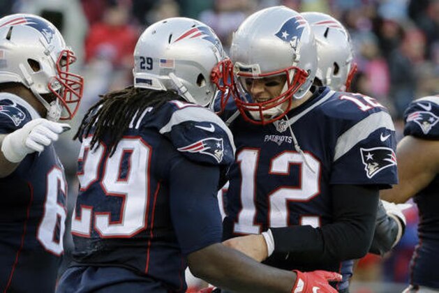 New England Patriots running back LeGarrette Blount, left, celebrates his touchdown against the New York Jets with Tom Brady (12) during the second half of an NFL football game, Saturday, Dec. 24, 2016, in Foxborough, Mass. (AP Photo/Elise Amendola)