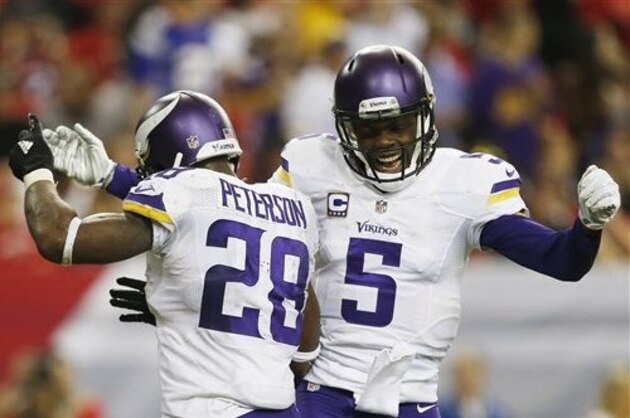 Minnesota Vikings running back Adrian Peterson (28) celebrates his touchdown with Minnesota Vikings quarterback Teddy Bridgewater (5) against the Atlanta Falcons during the second half of an NFL football game, Sunday, Nov. 29, 2015, in Atlanta. (AP Photo/Butch Dill)