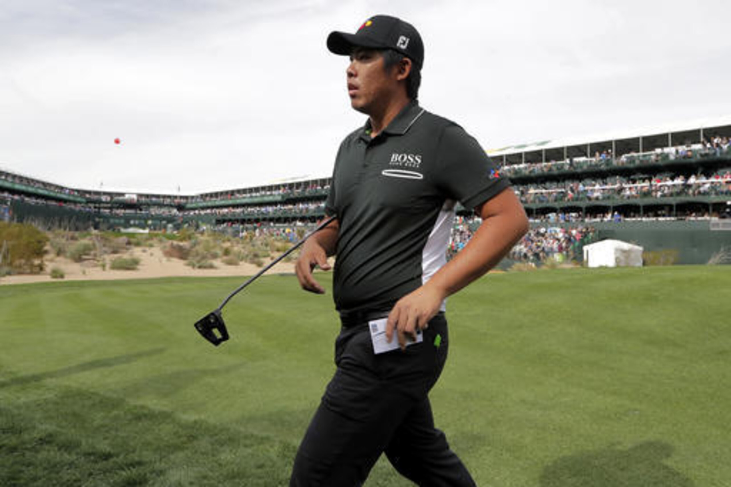 Byeong Hun An, of Korea, walks off the 16th green during the second round of the Phoenix Open golf tournament, Friday, Feb. 3, 2017, in Scottsdale, Ariz. (AP Photo/Matt York)