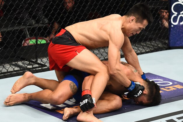 HOUSTON, TX - FEBRUARY 04:  (L-R) Chan Sung Jung of South Korea punches Dennis Bermudez in their featherweight bout during the UFC Fight Night event at the Toyota Center on February 4, 2017 in Houston, Texas. (Photo by Jeff Bottari/Zuffa LLC/Zuffa LLC via Getty Images)