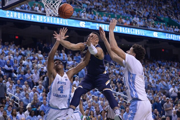GREENSBORO, NC - FEBRUARY 05:  Austin Torres #1 of the Notre Dame Fighting Irish battles Isaiah Hicks #4 and Justin Jackson #44 of the North Carolina Tar Heels for a rebound during the game at the Greensboro Coliseum on February 5, 2017 in Greensboro, North Carolina. The game, originally scheduled to be played on February 4 at the Dean Smith Center, was moved after a water emergency was declared in Chapel Hill.  (Photo by Grant Halverson/Getty Images)