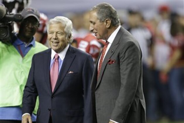 New England Patriots owner Robert Kraft, left, and Atlanta Falcons owner Arthur Blank speak at midfield before the first half of an NFL football game, Sunday, Sept. 29, 2013, in Atlanta. (AP Photo/John Bazemore)