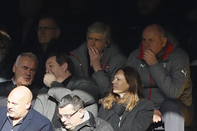 Arsenal's manager Arsene Wenger, centre top row, sits in the stands as he has a touchline ban imposed on him, after being sent off in a previous game, during the English Premier League soccer match between Chelsea and Arsenal at Stamford Bridge stadium in London, Saturday, Feb. 4, 2017. (AP Photo/Frank Augstein)