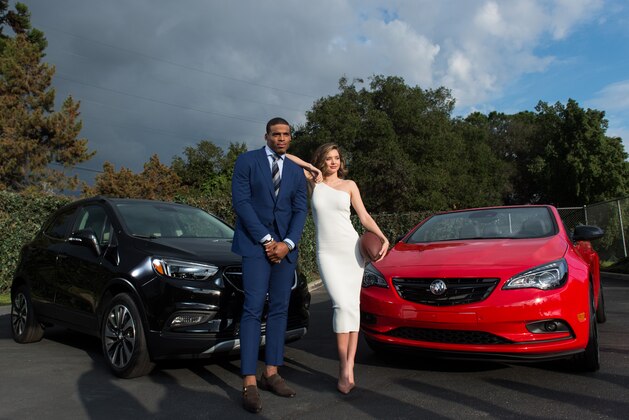 LOS ANGELES, CA - JANUARY 13:  Quarterback Cam Newton #1 of the Carolina Panthers (L) and model Miranda Kerr pose for a photo at 'Buick Super Bowl ad featuring the cascada and encore with football star Cam Newton and supermodel Miranda Kerr' on January 13, 2017 in Los Angeles, California.  (Photo by Emma McIntyre/Getty Images for Buick)