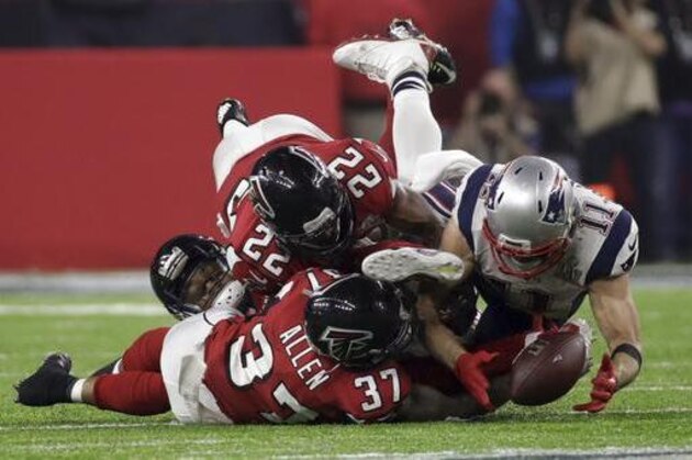 New England Patriots' Julian Edelman makes a catch as Atlanta Falcons' Ricardo Allen and Keanu Neal defend, during the second half of the NFL Super Bowl 51 football game Sunday, Feb. 5, 2017, in Houston. (AP Photo/Patrick Semansky)