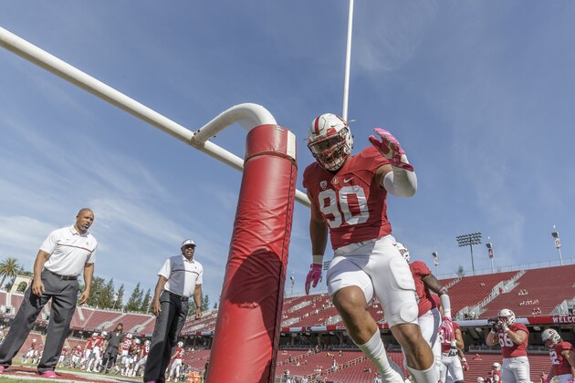 PALO ALTO, CA - OCTOBER 22:  Solomon Thomas #90 of the Stanford Cardinal warms up before an NCAA Pac-12 football game against the University of Colorado Buffaloes played on October 22, 2016 at Stanford Stadium on the campus of Stanford University in Palo Alto, California.  Also visible is Diron Reynolds, Stanford Assistant Defensive Line Coach (at far left); Tyrone McKenzie, Stanford Defensive Assistant (with visor);
 and Harrison Phillips #66.   (Photo by David Madison/Getty Images)