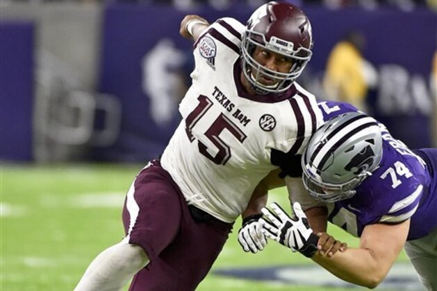 Texas A&M defensive lineman Myles Garrett (15) tries to get around Kansas State offensive lineman Scott Frantz during the second half of the Texas Bowl NCAA college football game, Wednesday, Dec. 28, 2016, in Houston. Kansas State won the game, 33-28. (AP Photo/Eric Christian Smith)