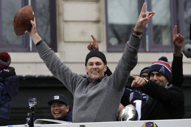New England Patriots quarterbacks Tom Brady and Jimmy Garoppolo, right, wave during a parade Tuesday, Feb. 7, 2017, in Boston to celebrate their 34-28 win over the Atlanta Falcons in Sunday's NFL Super Bowl 51 football game in Houston. (AP Photo/Charles Krupa)