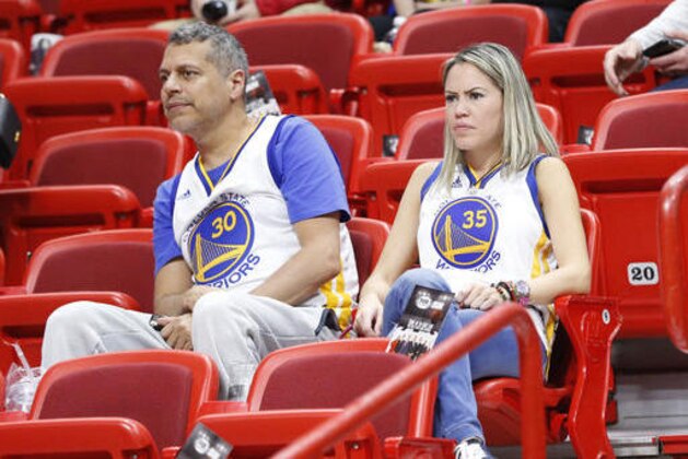 Golden State Warriors fans look on during warmups before the start of an NBA basketball game between the Miami Heat and the Golden State Warriors, Monday, Jan. 23, 2017, in Miami. (AP Photo/Wilfredo Lee)
