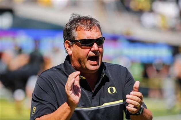 Oregon defensive coordinator Brady Hoke warms up the defensive linemen before playing UC Davis during an NCAA college football game in Eugene, Ore., Saturday, Sept. 3, 2016. (AP Photo/Thomas Boyd)