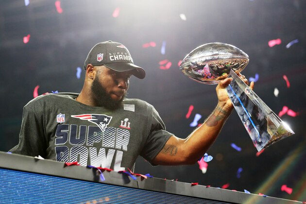 HOUSTON, TX - FEBRUARY 05:  James White #28 of the New England Patriots holds the Vince Lombardi Trophy to celebrate after defeating the Atlanta Falcons 34-28 in overtime during Super Bowl 51 at NRG Stadium on February 5, 2017 in Houston, Texas.  (Photo by Tom Pennington/Getty Images)