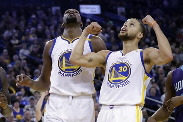 Golden State Warriors' Stephen Curry (30) reacts after a score from teammate Kevin Durant during the second half of the team's NBA basketball game against the Charlotte Hornets on Wednesday, Feb. 1, 2017, in Oakland, Calif. (AP Photo/Marcio Jose Sanchez)