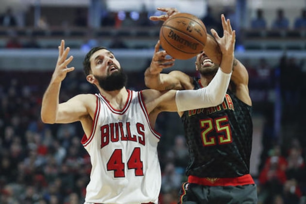 Chicago Bulls forward Nikola Mirotic (44) fouls Atlanta Hawks forward Thabo Sefolosha (25) during the first half of an NBA basketball game, Wednesday, Jan. 25, 2017, in Chicago. (AP Photo/Kamil Krzaczynski)