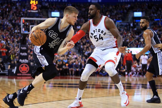 TORONTO, ON - JANUARY 24:  Davis Bertans #42 of the San Antonio Spurs dribbles the ball as Patrick Patterson #54 of the Toronto Raptors defends during the second half of an NBA game at Air Canada Centre on January 24, 2017 in Toronto, Canada.  NOTE TO USER: User expressly acknowledges and agrees that, by downloading and or using this photograph, User is consenting to the terms and conditions of the Getty Images License Agreement.  (Photo by Vaughn Ridley/Getty Images)