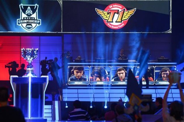 The team of South Korea's SK Telecom T1 react as they win the League of Legends Season 3 World Championship Final over China's Royal Club, Friday, Oct. 4, 2013, in Los Angeles. The SK Telecom T1 team won 3-0. (AP Photo/Mark J. Terrill)