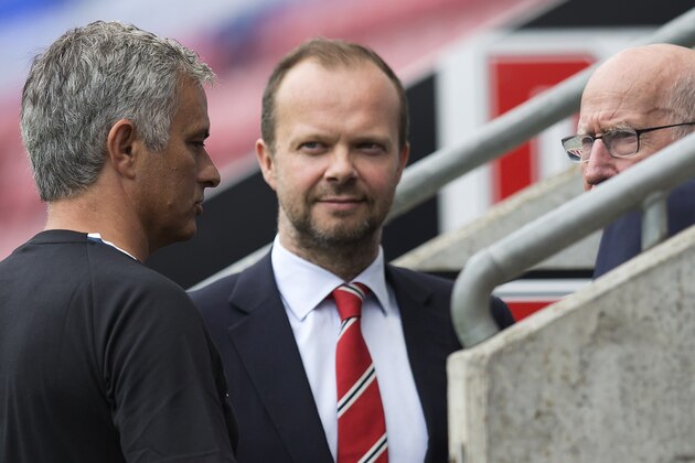 Manchester United's executive vice-chairman Ed Woodward (C) listens as Manchester United's Portuguese manager Jose Mourinho (L) talks with former Manchester United player Bobby Charlton following the pre-season friendly football match between Wigan Athletic and Manchester United at the DW stadium in Wigan, northwest England, on July 16, 2016.  / AFP / JON SUPER / RESTRICTED TO EDITORIAL USE. No use with unauthorized audio, video, data, fixture lists, club/league logos or 'live' services. Online in-match use limited to 75 images, no video emulation. No use in betting, games or single club/league/player publications.  /         (Photo credit should read JON SUPER/AFP/Getty Images)
