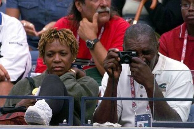 Richard Williams takes a picture while he and his wife Oracene  watch their daughter Venus Williams, of Palm Beach Gardens, Fla. during her match against Mary Joe Fernandez, of Miami, Fla. at the U.S. Open Sunday, Sept. 5, 1999 in New York. (AP Photo/Mark Lennihan)