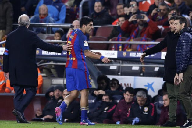 Barcelona's Luis Suarez leaves the pitch after being shown a red card during the the Copa del Rey semifinal second leg soccer match between FC Barcelona and Atletico Madrid at the Camp Nou stadium in Barcelona, Spain, Tuesday Feb. 7, 2017. (AP Photo/Manu Fernandez)