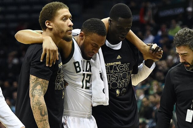 MILWAUKEE, WI - FEBRUARY 08:  Jabari Parker #12 of the Milwaukee Bucks is helped off the court by Michael Beasley (L) and Thon Maker during the second half of a game against the Miami Heat at the BMO Harris Bradley Center on February 8, 2017 in Milwaukee, Wisconsin. NOTE TO USER: User expressly acknowledges and agrees that, by downloading and or using this photograph, User is consenting to the terms and conditions of the Getty Images License Agreement.  (Photo by Stacy Revere/Getty Images)