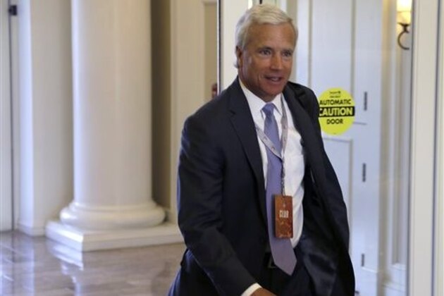 Danny Morrison, president of football operations for the Carolina Panthers,  makes his way into the NFL owner's meeting in Charlotte N.C., Tuesday, May 24, 2016. (AP Photo/Bob Leverone)