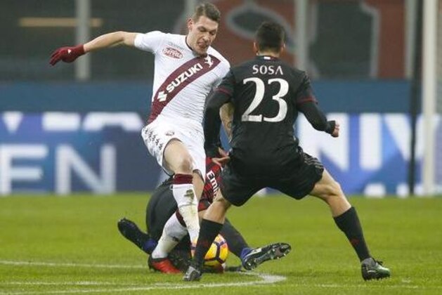 Torino's Andrea Belotti, left, takes on AC Milan's Jose' Sosa during an Italian Cup, Round of 16 soccer match, at the San Siro stadium in Milan, Italy, Thursday, Jan. 12, 2017. (AP Photo/Antonio Calanni)