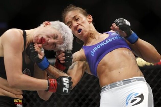Germaine de Randamie, right, of the Netherlands, right, punches Larissa Pacheco, of Brazil, during a women's bantamweight UFC bout, Saturday, March 14, 2015, in Dallas. Randamie won in two rounds. (AP Photo/Brandon Wade)