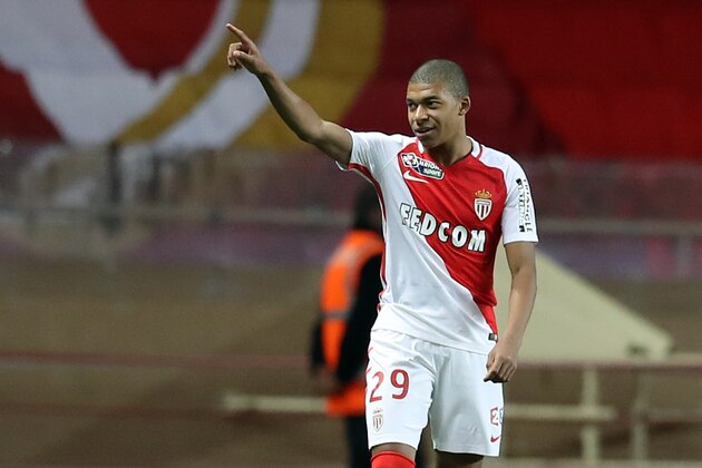 Monaco's French forward Kylian Mbappe Lottin celebrates after scoring during a French League Cup football match between Monaco (ASM) vs Rennes (SRFC) at the 'Louis II' stadium in Monaco on December 14, 2016. / AFP / VALERY HACHE        (Photo credit should read VALERY HACHE/AFP/Getty Images)