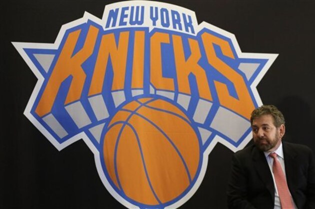 James Dolan, executive chairman of  Madison Square Garden, sits at a news conference next to the team logo where he introduced Phil Jackson as the new president of the New York Knicks, Tuesday, March 18, 2014 in New York. Jackson, who won two NBA titles as a player for the New York Knicks, also won 11 championships while coaching the Chicago Bulls and the Los Angeles Lakers. (AP Photo/Mark Lennihan)