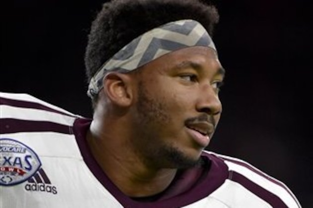 Texas A&M defensive lineman Myles Garrett (15) looks on during warmups before the Texas Bowl NCAA college football game against Kansas State, Wednesday, Dec. 28, 2016, in Houston. (AP Photo/Eric Christian Smith)