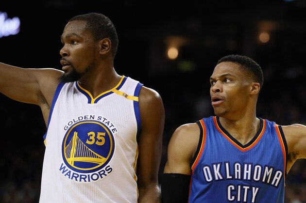 OAKLAND, CA - JANUARY 18:  Kevin Durant #35 of the Golden State Warriors and Russell Westbrook #0 of the Oklahoma City Thunder point in different directions after the ball went out of bounds at ORACLE Arena on January 18, 2017 in Oakland, California.  NOTE TO USER: User expressly acknowledges and agrees that, by downloading and or using this photograph, User is consenting to the terms and conditions of the Getty Images License Agreement.  (Photo by Ezra Shaw/Getty Images)