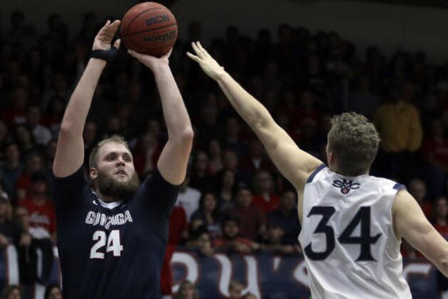 Gonzaga's Przemek Karnowski, left, shoots against Saint Mary's Jock Landale (34) during the first half of an NCAA college basketball game Saturday, Feb. 11, 2017, in Moraga, Calif. (AP Photo/Ben Margot)