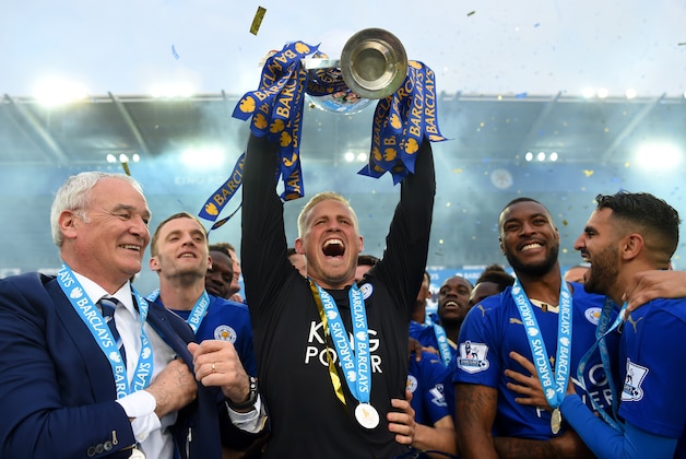 LEICESTER, ENGLAND - MAY 07:  Kasper Schmeichel of Leicester City lifts the Premier League Trophy as players and staffs celebrate the season champion after the Barclays Premier League match between Leicester City and Everton at The King Power Stadium on May 7, 2016 in Leicester, United Kingdom.  (Photo by Michael Regan/Getty Images)