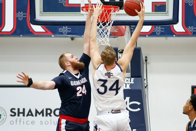 Feb 11, 2017; Moraga, CA, USA; Gonzaga Bulldogs center Przemek Karnowski (24) attempts to defend against St. Mary's Gaels center Jock Landale (34) during the second half of the game at McKeon Pavilion. The Gonzaga Bulldogs defeated the St. Mary's Gaels with a score of 74-64.  Mandatory Credit: Stan Szeto-USA TODAY Sports