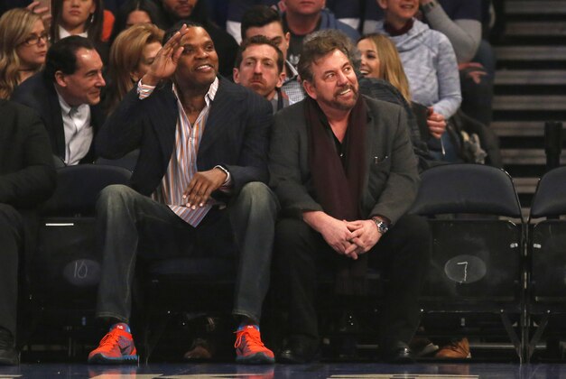 Feb 12, 2017; New York, NY, USA; Latrell Sprewell waves sitting next to New York Knicks executive chairman James L. Dolan during the first quarter against the San Antonio Spurs at Madison Square Garden. Mandatory Credit: Adam Hunger-USA TODAY Sports