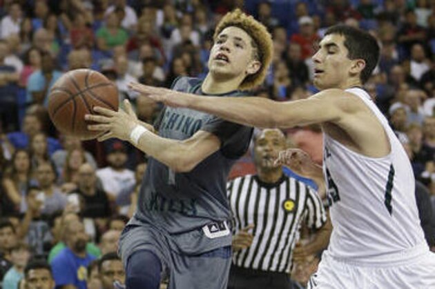 Chino Hills' Lamelo Ball, left, goes to the basket against De La Salle's Jordan Ratinho during the second half of the CIF boys' Open Division high school basketball championship game Saturday, March 26, 2016, in Sacramento, Calif. Chino Hills won 70-50. (AP Photo/Rich Pedroncelli)