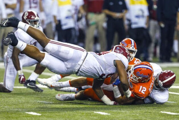 Florida quarterback Austin Appleby (12) is sacked by Alabama defensive lineman Jonathan Allen (93) and linebacker Tim Williams (56) during the first half of the Southeastern Conference championship NCAA college football game, Saturday, Dec. 3, 2016, in Atlanta.(AP Photo/Butch Dill)